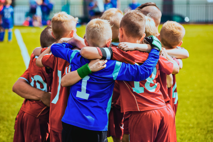 Young boys soccer team in a huddle on the field