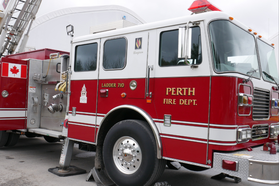 Side of red fire truck with Perth Fire Dept. written on the passenger door
